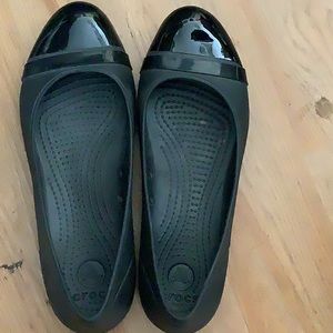 Flat black crocs, size w 8. Shiny toe.